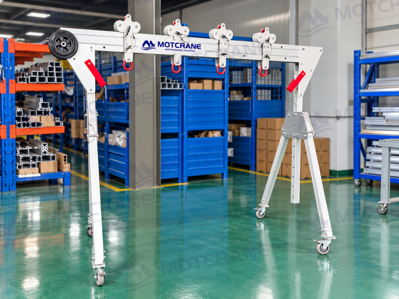 Aluminum gantry crane with caster wheels on a smooth workshop floor